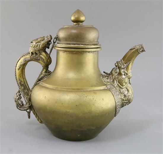A 19th century Tibetan brass and silver overlaid teapot H. 29cm